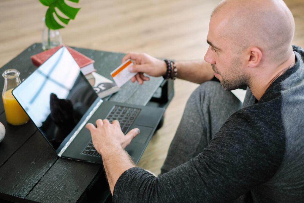 Man using laptop to pay for counseling session